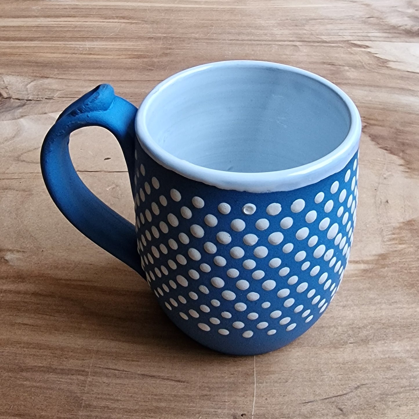 Light colored clay mug with illustrations (MASP 77)