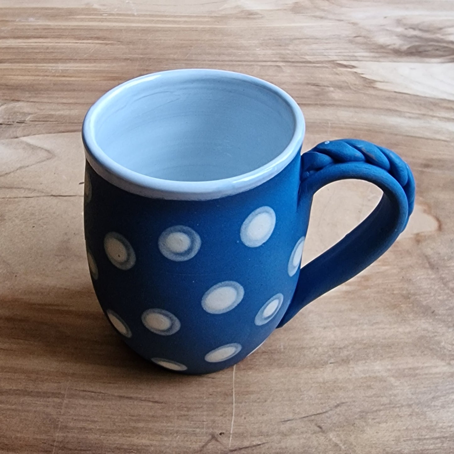 Light colored clay mug with illustrations (MASP 77)