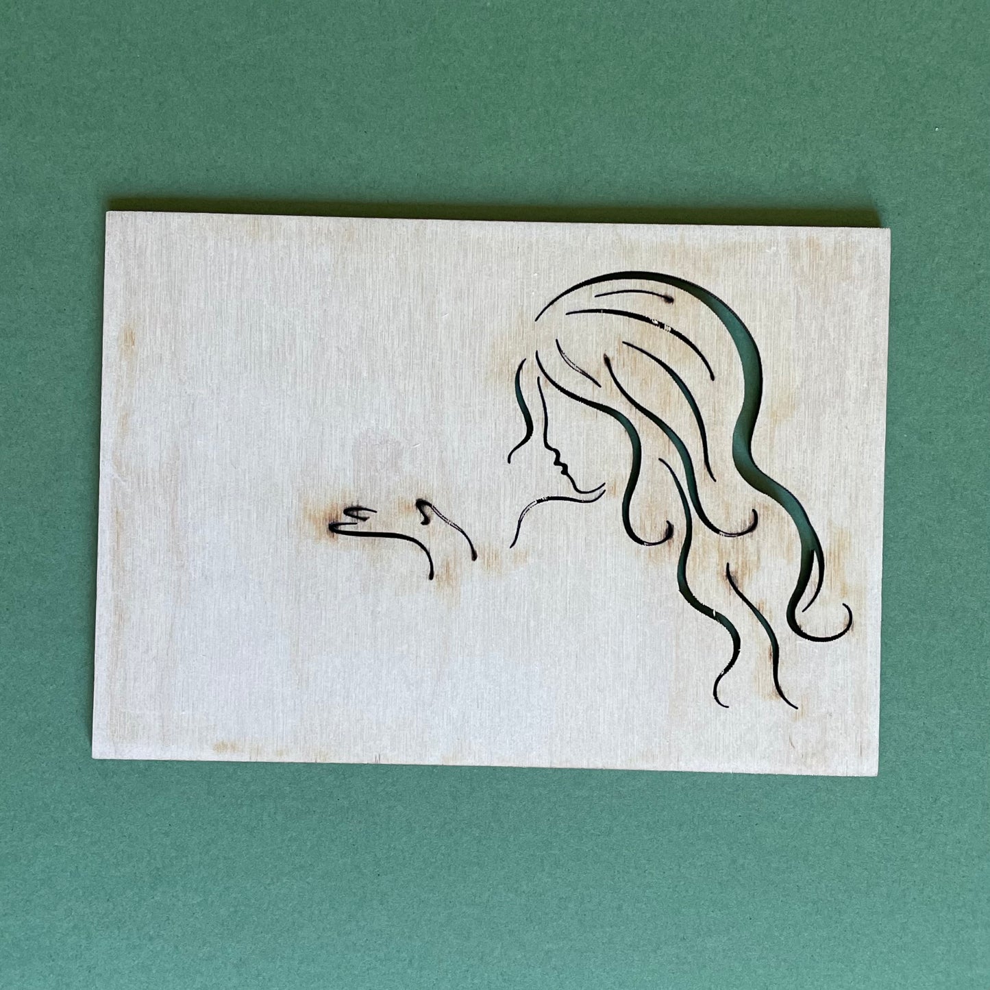 Plywood postcard with milled silhouette of a woman (RAJO 43)