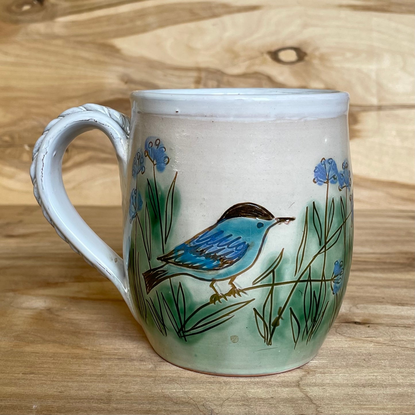 Light colored clay mug with illustrations (MASP 77)