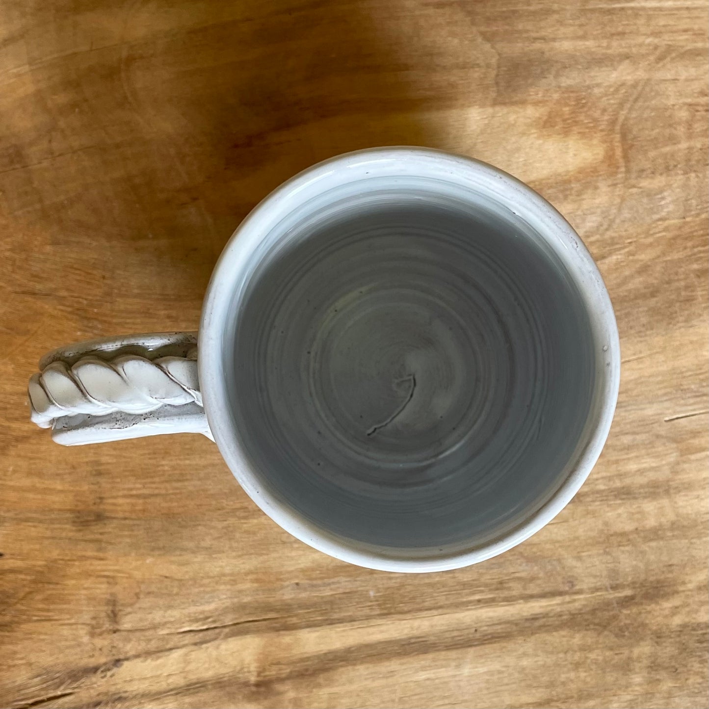 Light colored clay mug with illustrations (MASP 77)