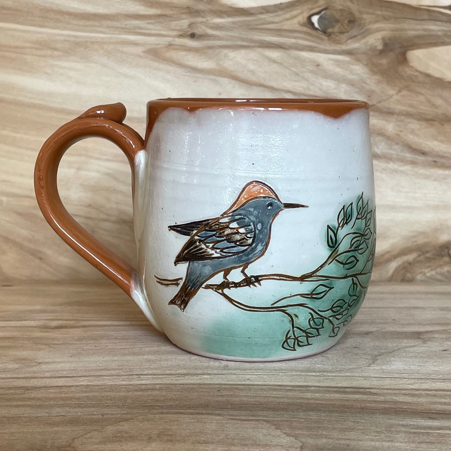 Light colored clay mug with illustrations (MASP 77)