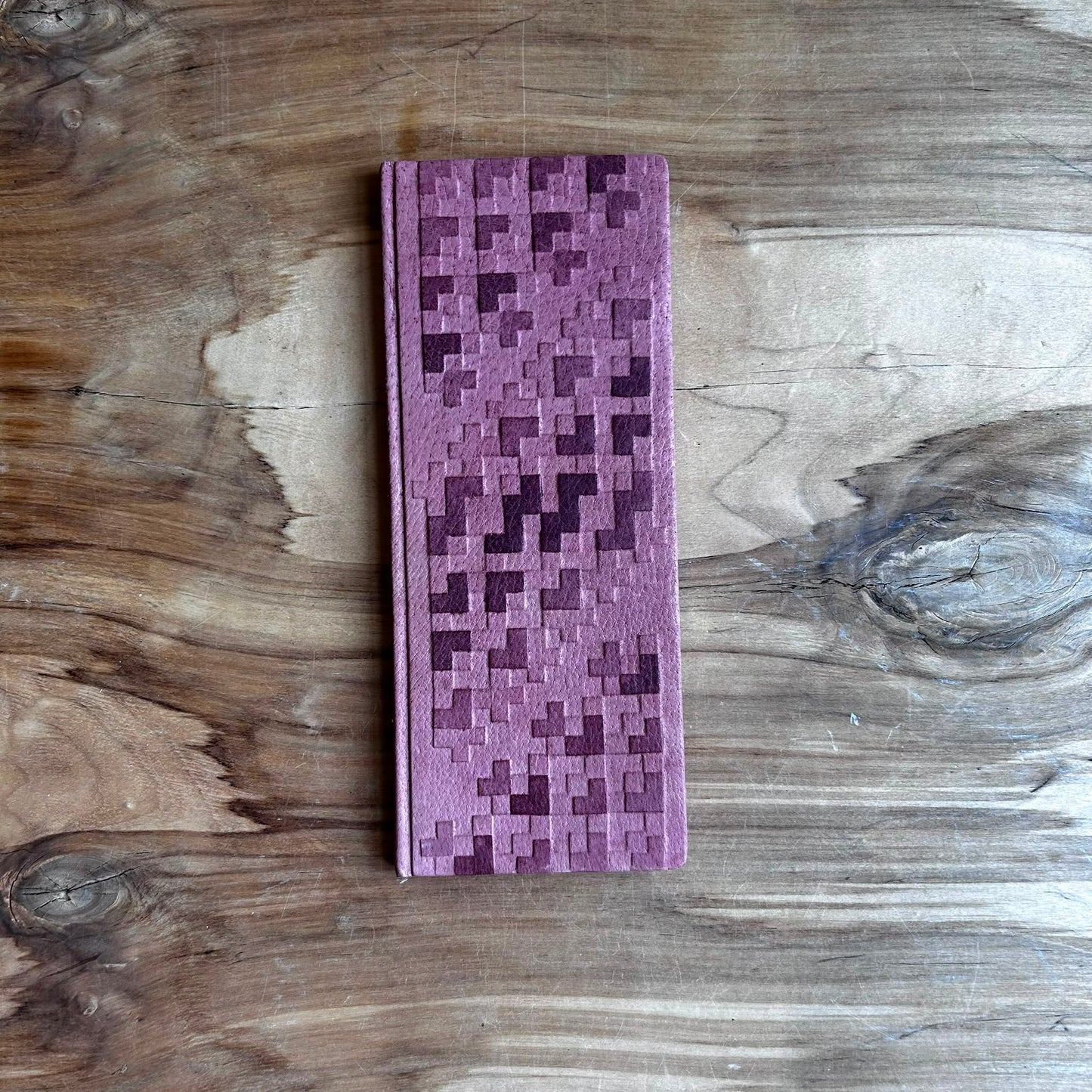 Bloknots ar līniju lapām un latviešu alfabētu, rozā krāsas ādas ievākojumā (MAPL 26)