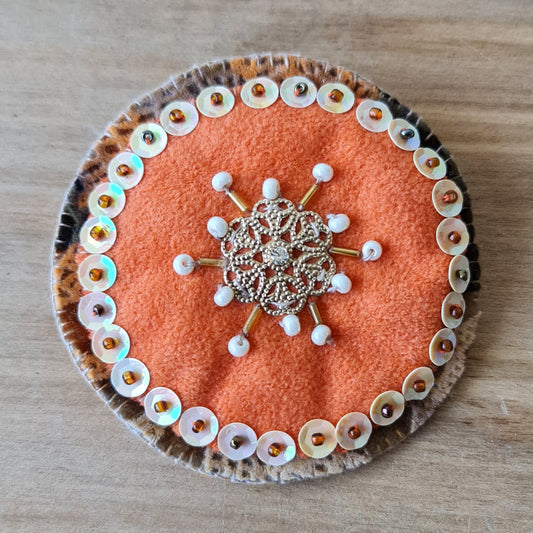 Sewn round brooch with pearl accents in orange/brown/gold tones / diameter 7.5 cm (AMA)