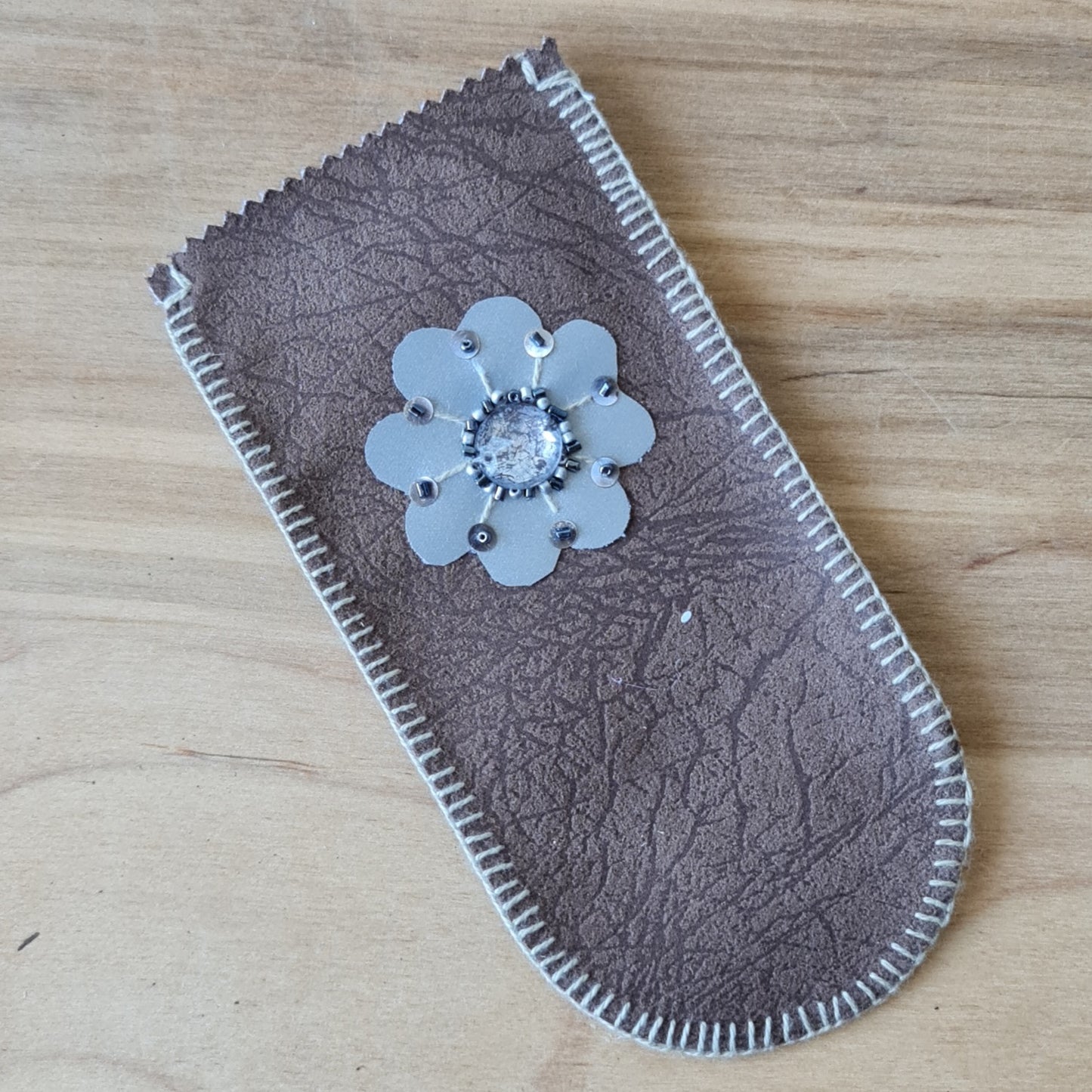 Stitched glasses case in brown color made of suede type fabric with reflective sun sign on one side and oak on the other side and white cotton lining 17 x 8.5 cm (AMA)
