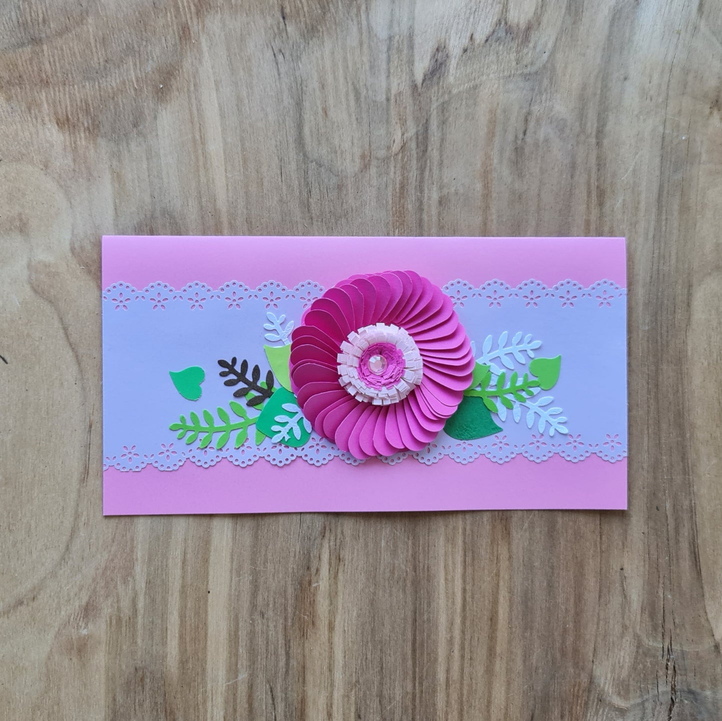 Paper card 3D on light pink background dark pink flower with decorative green leaves and light band with lace-like edges 21 x 10.5 cm (AMA)