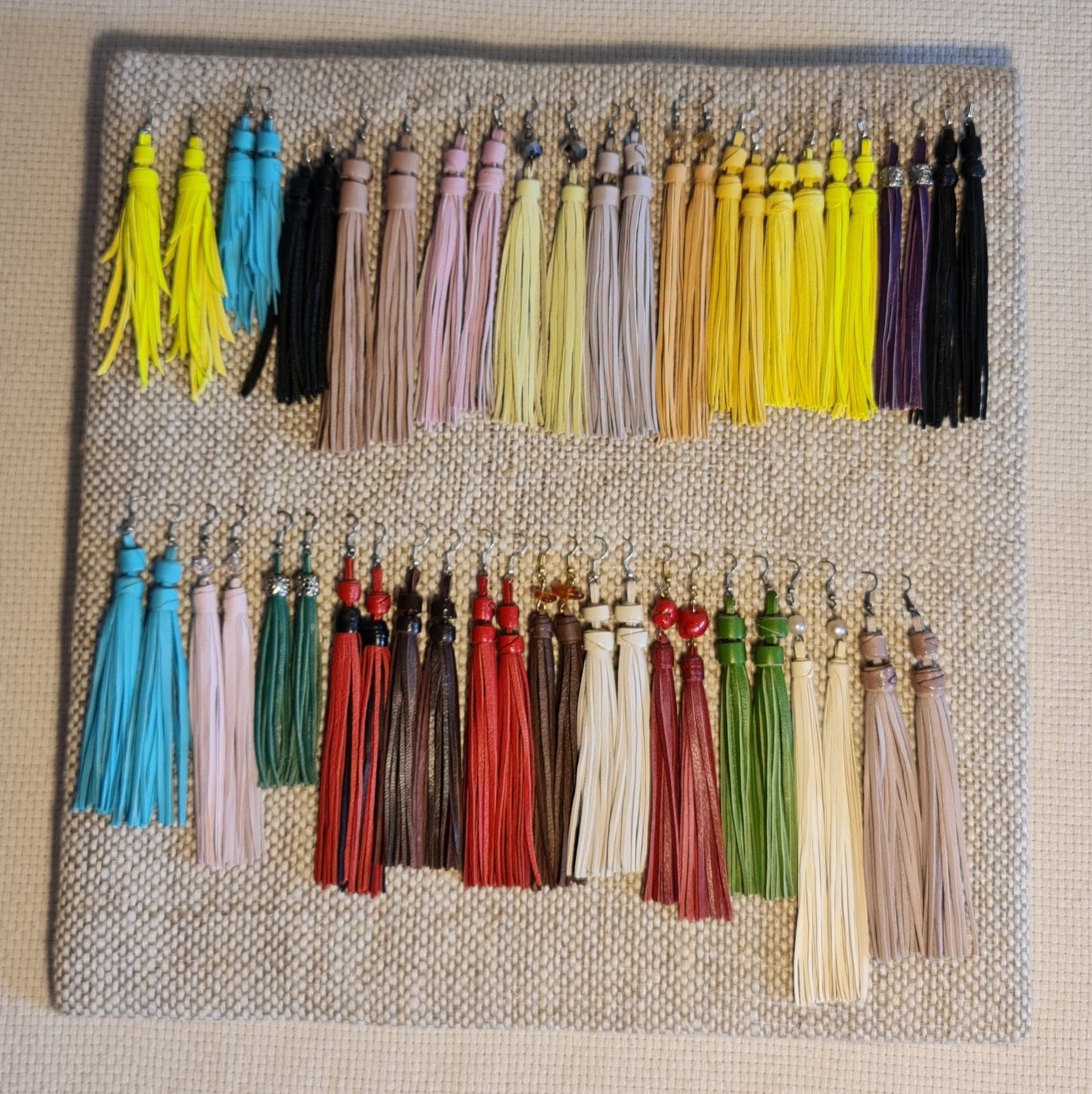 Light leather ribbon earrings in ivory color of equal length leather strips with beads on top (length 15.5 cm) bottom row 11th from the left (JŠČ)