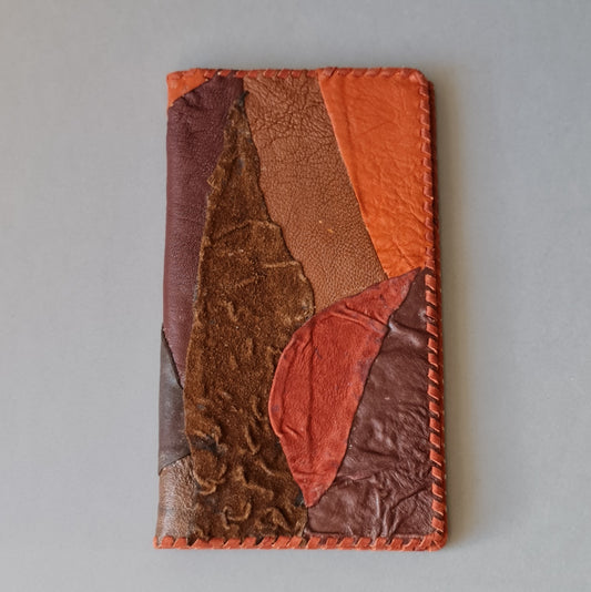 Diary. The calendar part is changeable. Leather covers in brown / reddish / orange shades. 10.5 x 18.5 cm (MAPL)