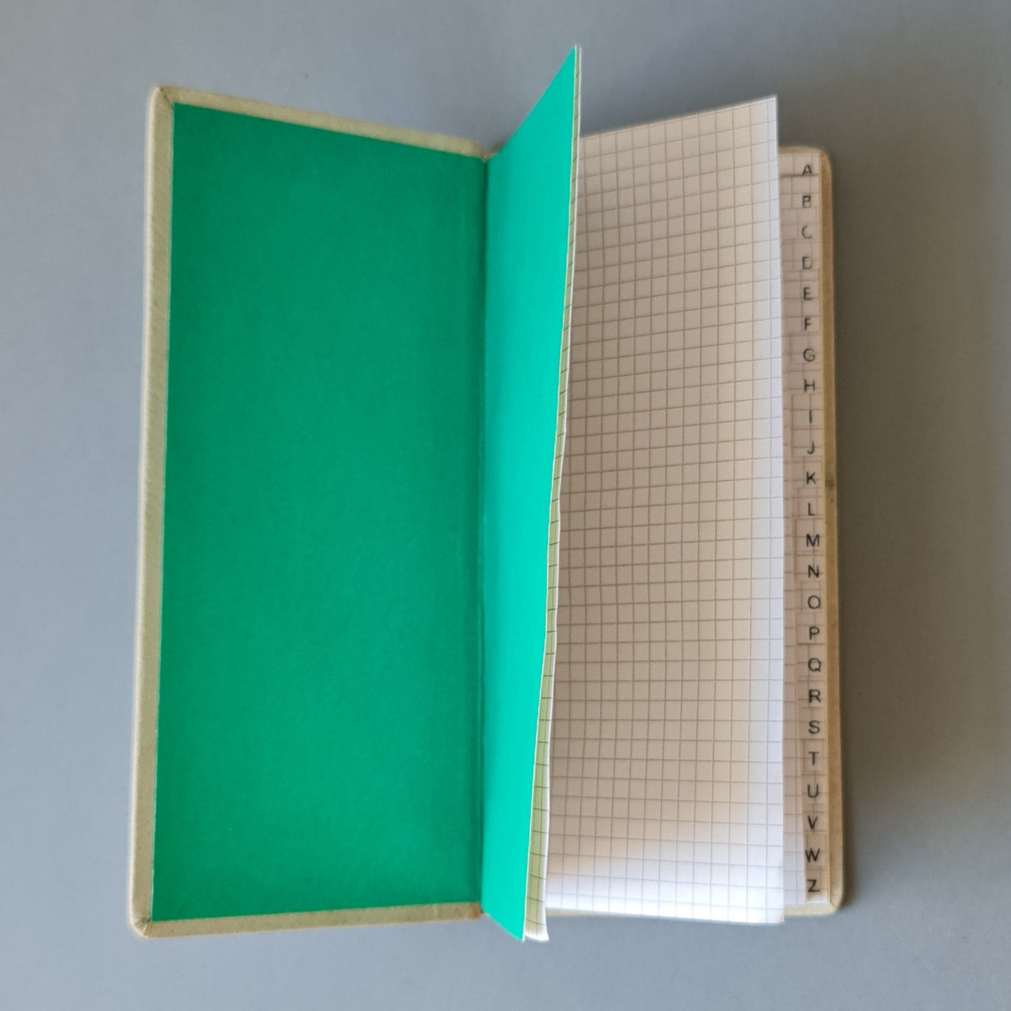 Telephone book with the alphabet in Latvian in a leather cover. Light green color with a decorative print. Long 10 x 21.5 x 1.2 cm (MAPL)